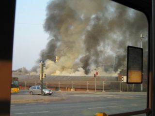 [Smoke rising behind a building] 